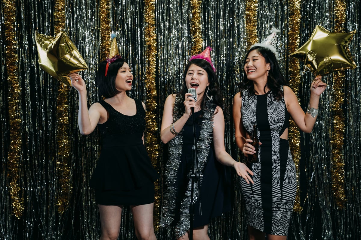 Ladies Enjoying Music in Karaoke Party